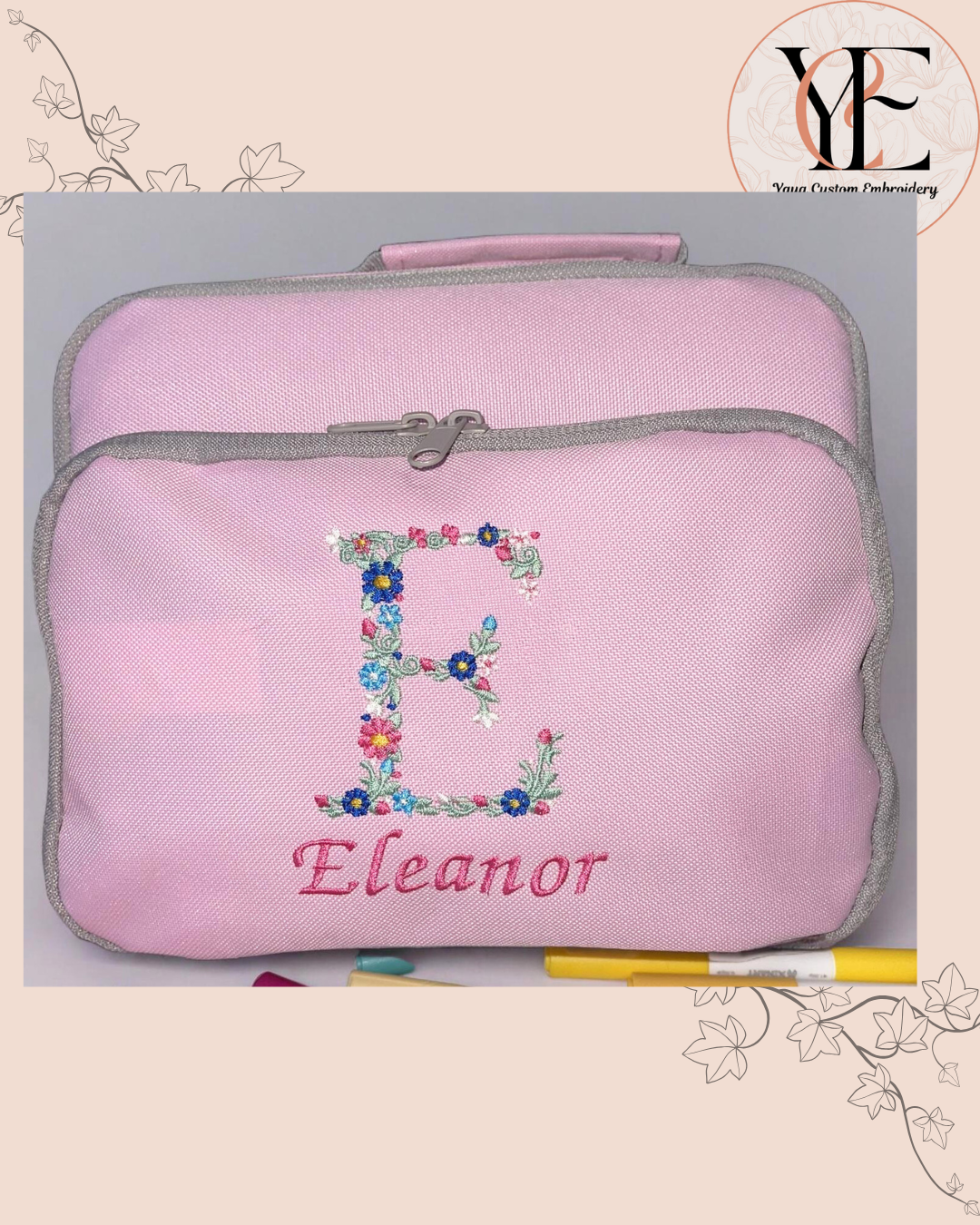 Pink lunch box with floral letter 'E' and name 'Eleanor', grey zipper