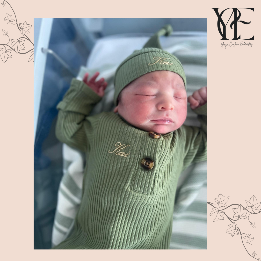 Close up of baby wearing a personalised olive baby grow and hat. By Yaya Custom Embroidery.