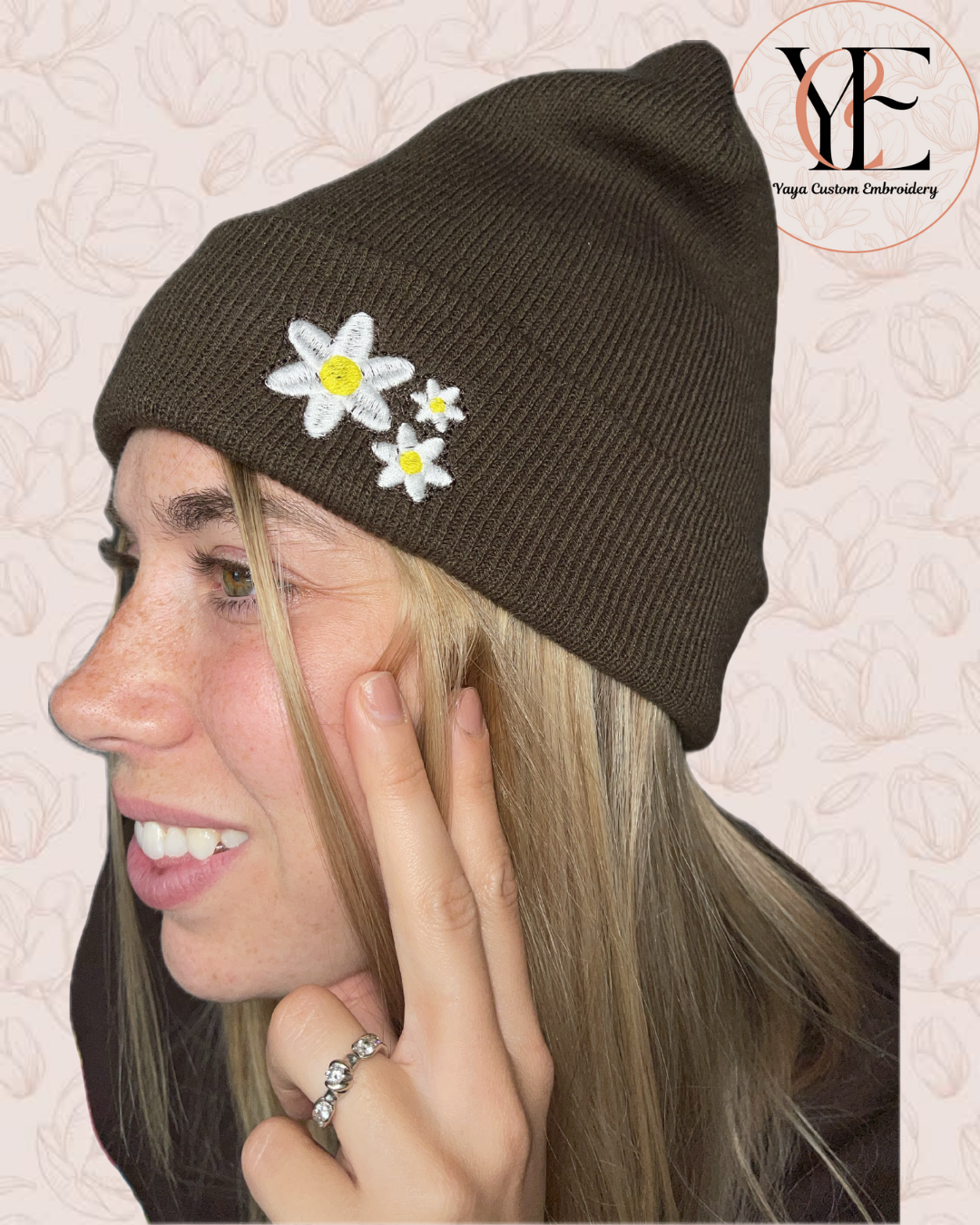 Woman wearing a Chocolate brown beanie with embroidered flowers, with 'YCE' logo in the corner.