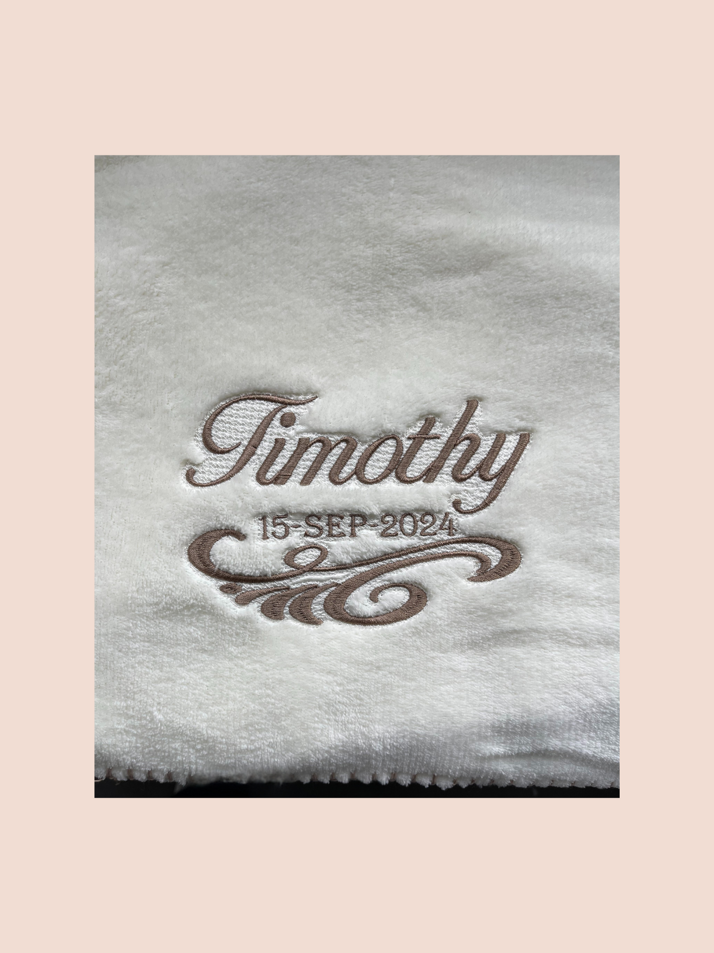 Close up of Embroidered name and date on a baby blanket