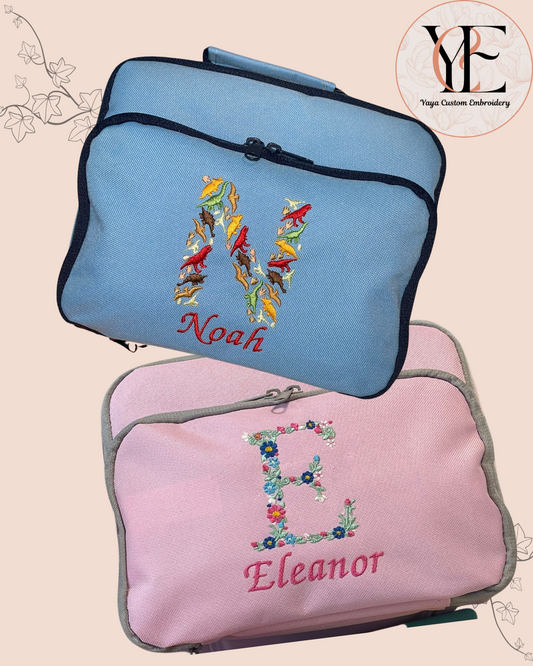2 Cool bags personalised with initial and the name. The Initials are made of dinosaurs (Sky Blue bag) and Flowers (Classic pink lunch bag)