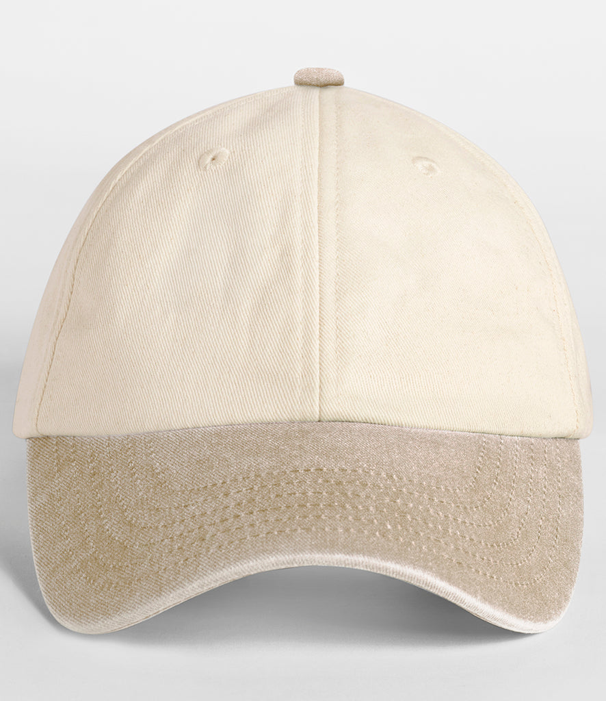 A classic six-panel baseball cap in a light cream color with a contrasting light tan brim, shown against a neutral light gray background.