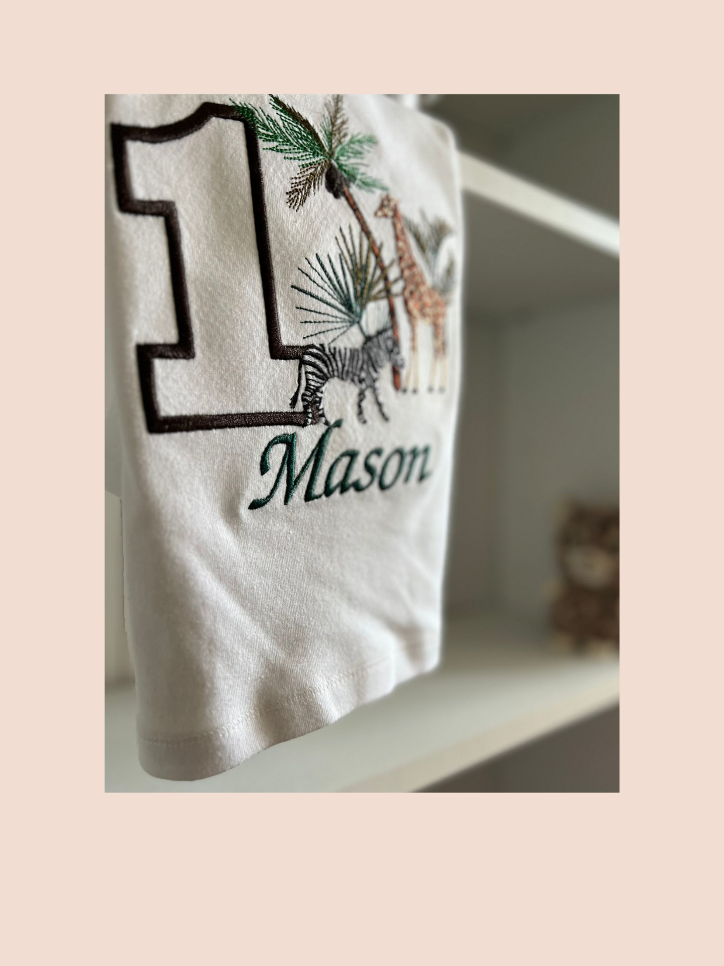 Close up of a Safari themed Birthday sweatshirt personalised with the number 1 and name Mason