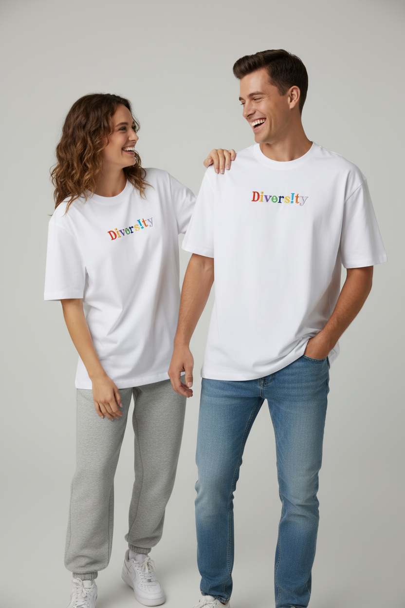 Two people wearing white t-shirts with 'Diversity' embroidered on them, standing against a plain background.