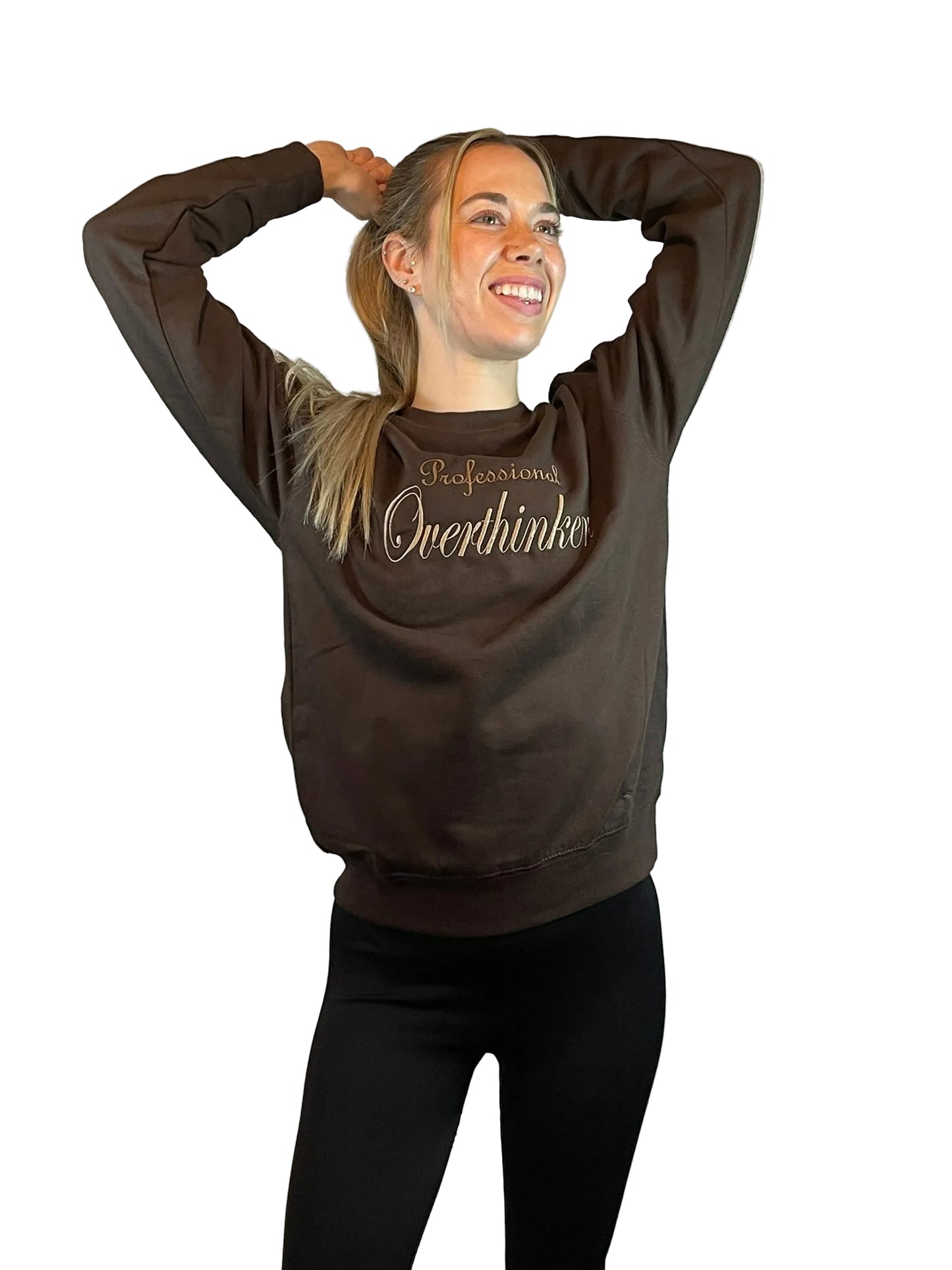 Person wearing a brown sweatshirt with Professional Overthinker text embroidered,