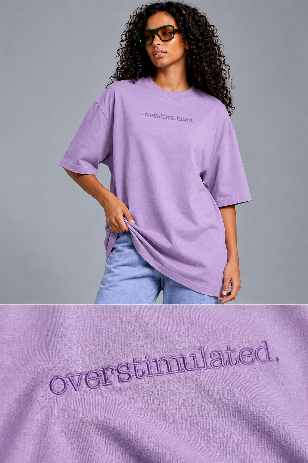 A model wearing an oversized lavender t-shirt with 'overstimulated.' embroidered on the chest, paired with light blue jeans, against a solid gray studio background.