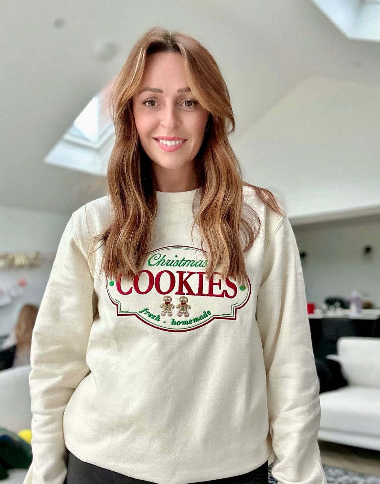 Lady wearing the vanilla colour Embroidered Cookie Christmas Label Sweatshirt