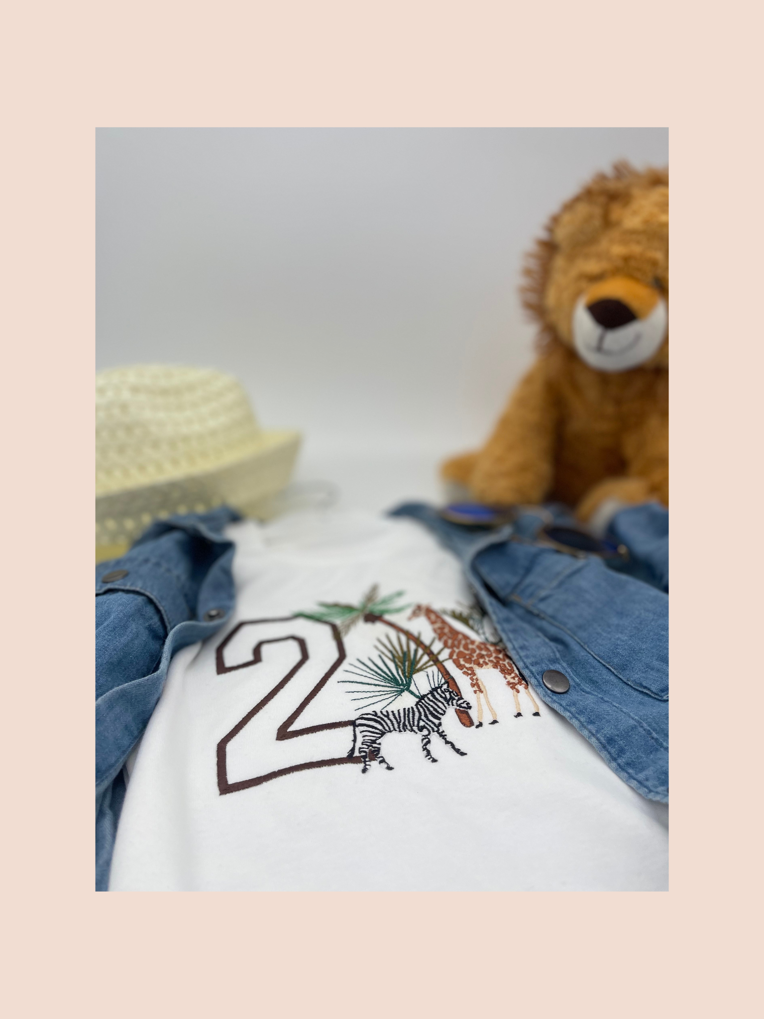 Flat perspective of a embroidered safari birthday sweatshirt personalised with the number 2