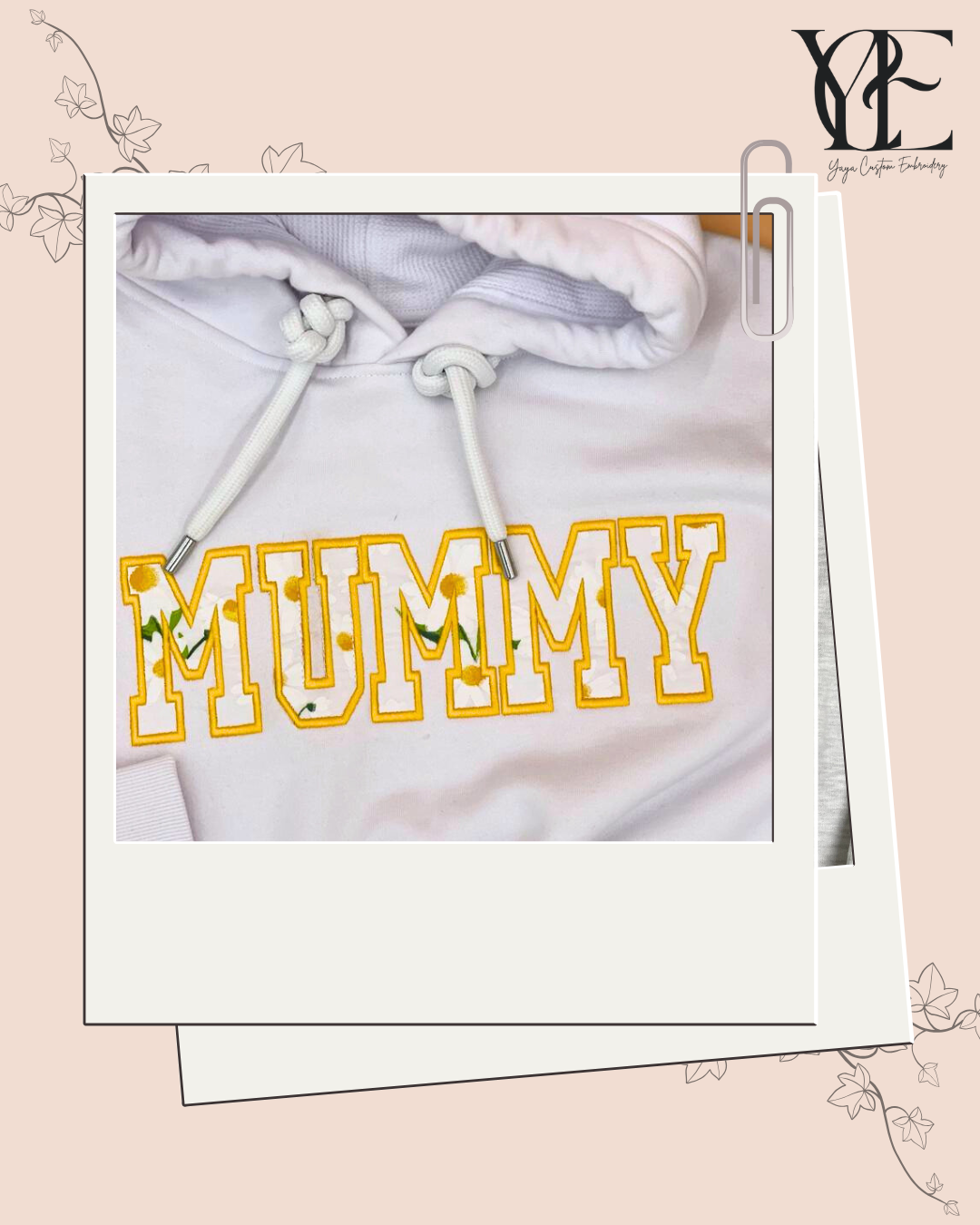 Close up of a MUMMY embroidered on a white hoodie using a College applique font with yellow outline and a sweet daisy applique material.