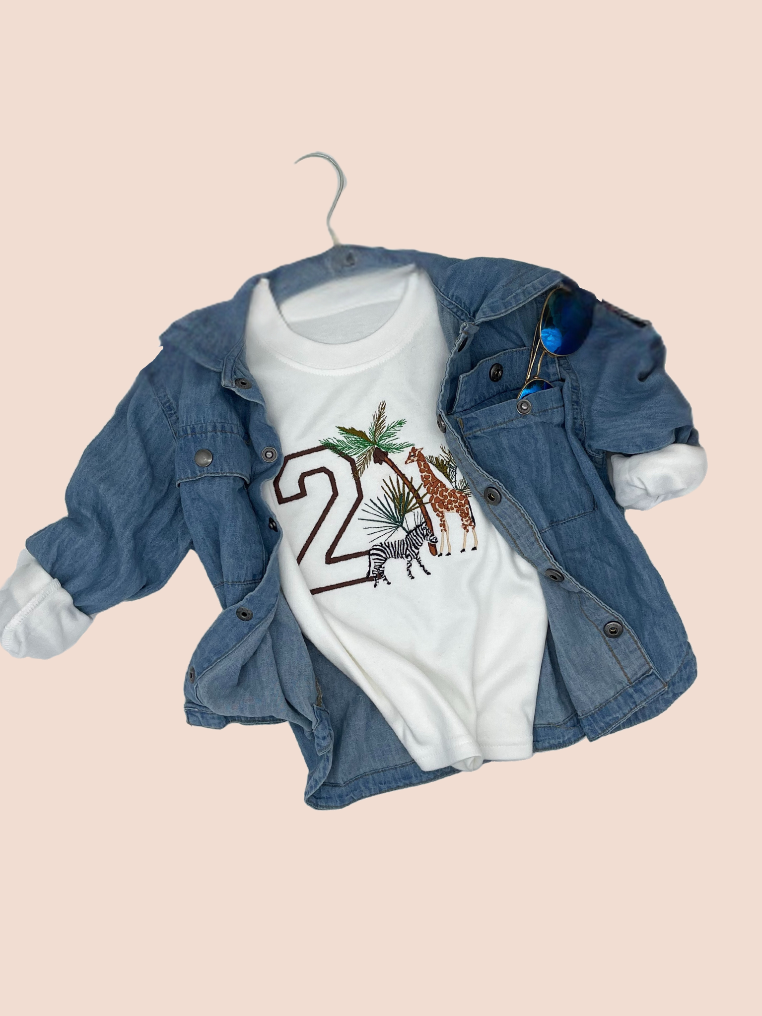 Top view of a 2 Birthday Safari Sweatshirtcomplemented with a denim shirt.